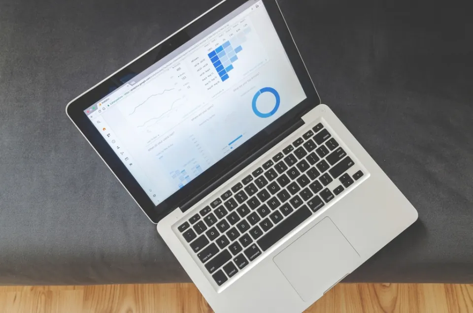 A laptop seen from above with analytics charts on the screen
